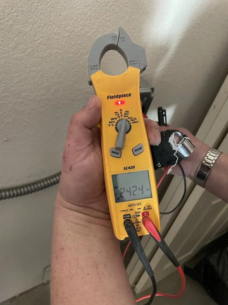 Voltage testing with clamp meter during Recessed Lighting Installation in Ramsey